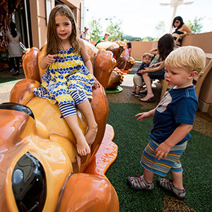 Girl in Blue and Yellow Outfit Playing on Soft Outdoor Equipment