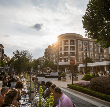Long Table of People Eating Outdoors